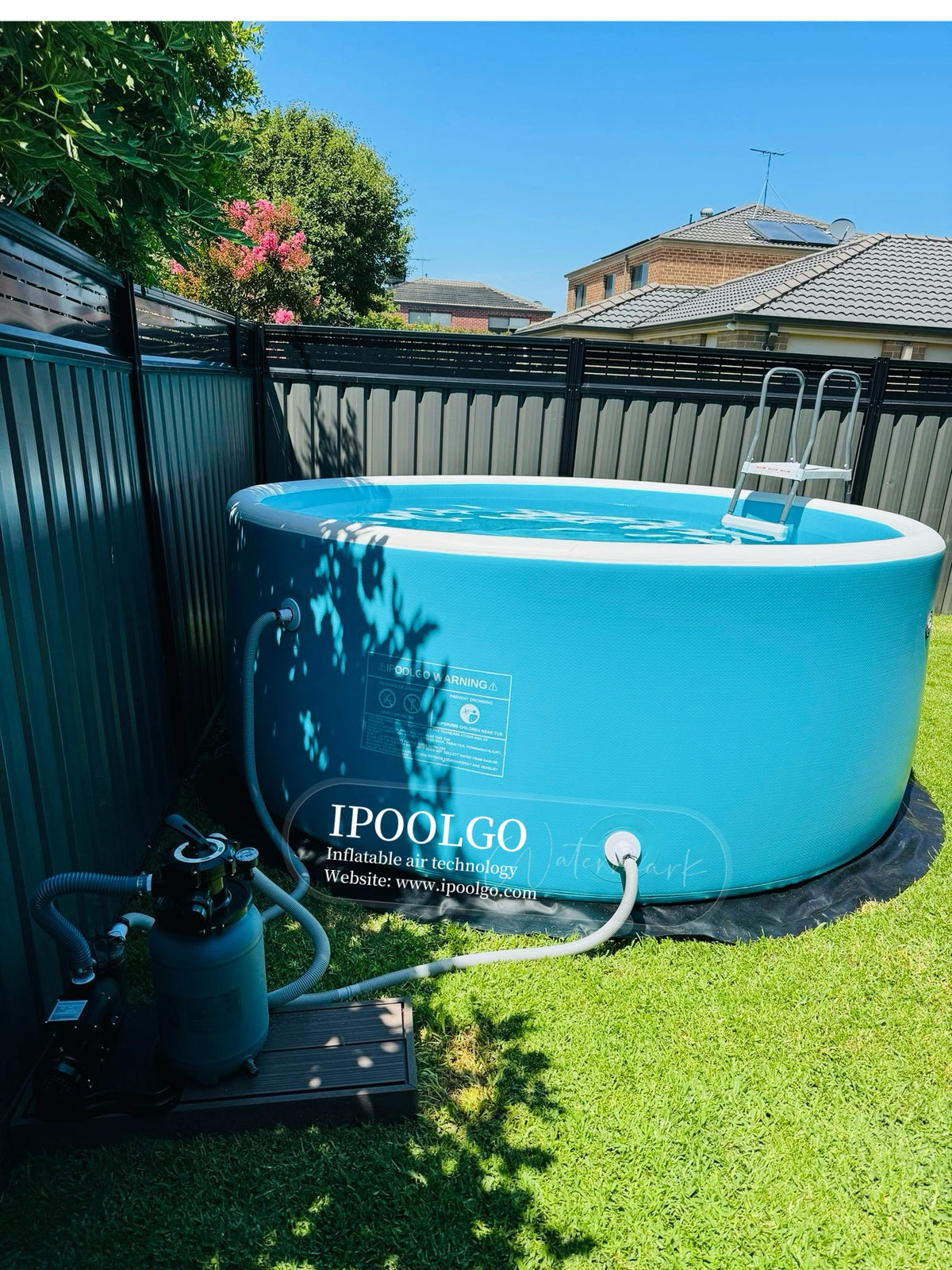 Drop stitch pool in a backyard with filter and ladder
