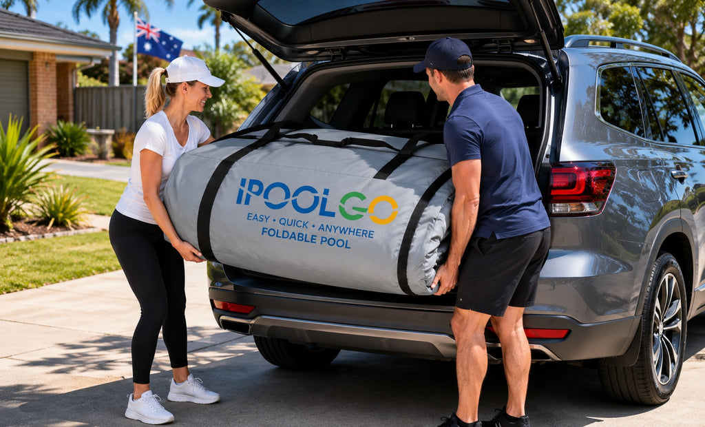 Two people loading the packed pool in its carry bag into a car